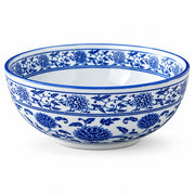 A white ceramic bowl decorated with a classic blue floral and vine pattern, shown against a plain white background.