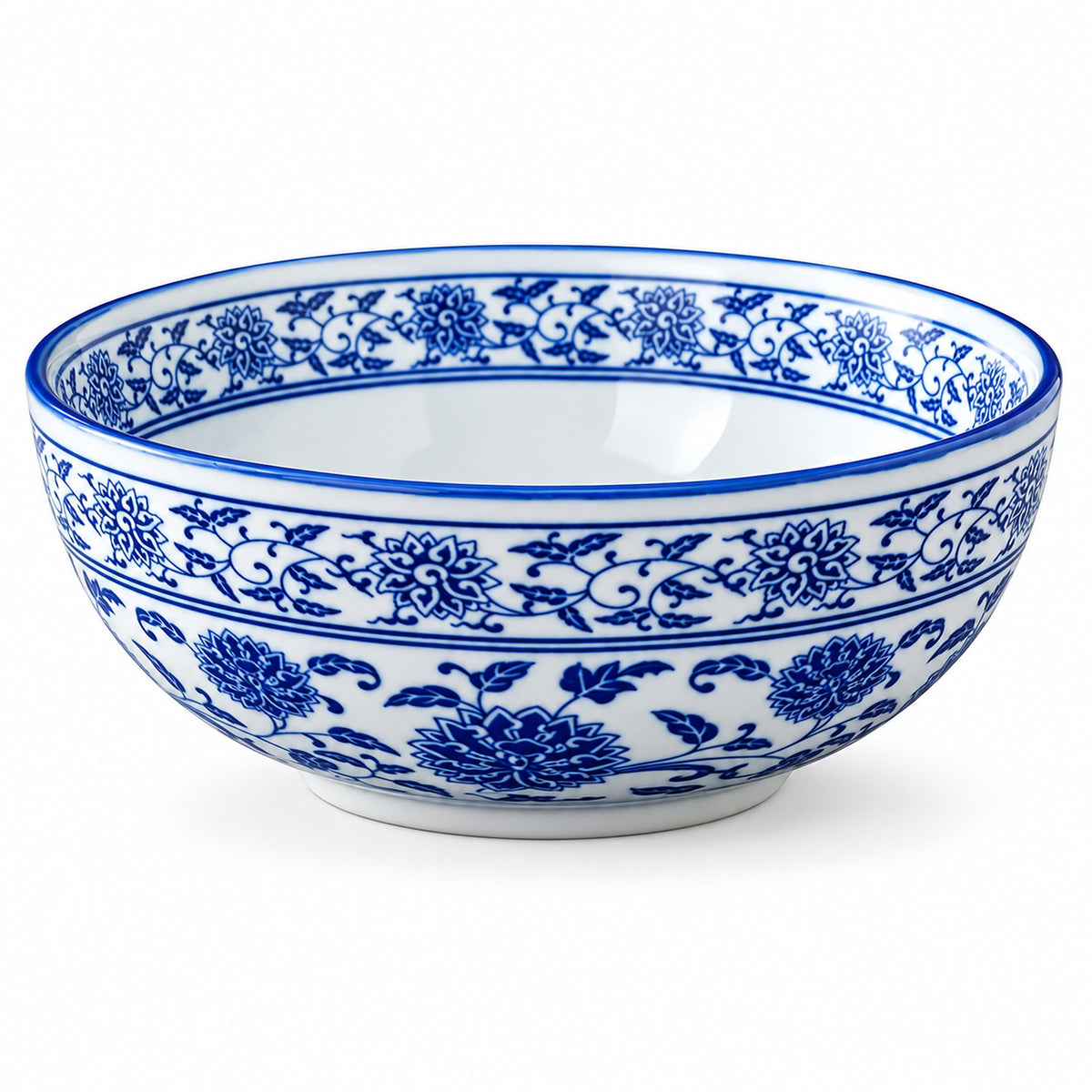 A white ceramic bowl decorated with a classic blue floral and vine pattern, shown against a plain white background.