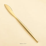 Gold dinner knife, approximately 22 cm long.