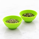 Two mini silicone bowls keeping dried herbs separate.
