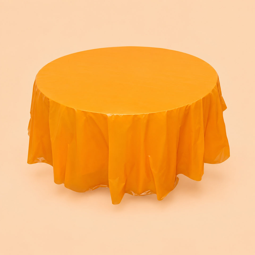 One orange disposable PVC tablecloth draped over a round table.