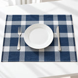 One blue-and-white plaid towel used beneath a dining plate.