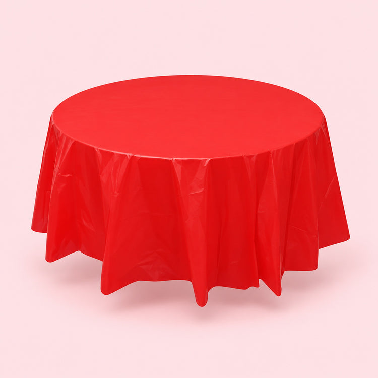 One red disposable PVC tablecloth draped over a round table.