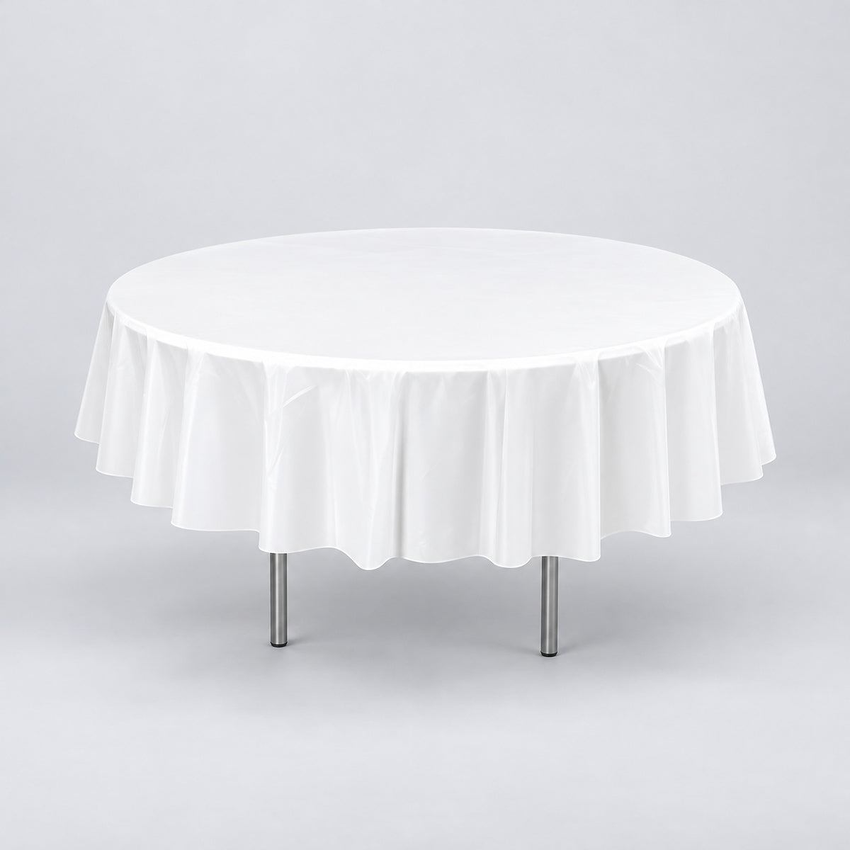 One white disposable PVC tablecloth draped over a round table.