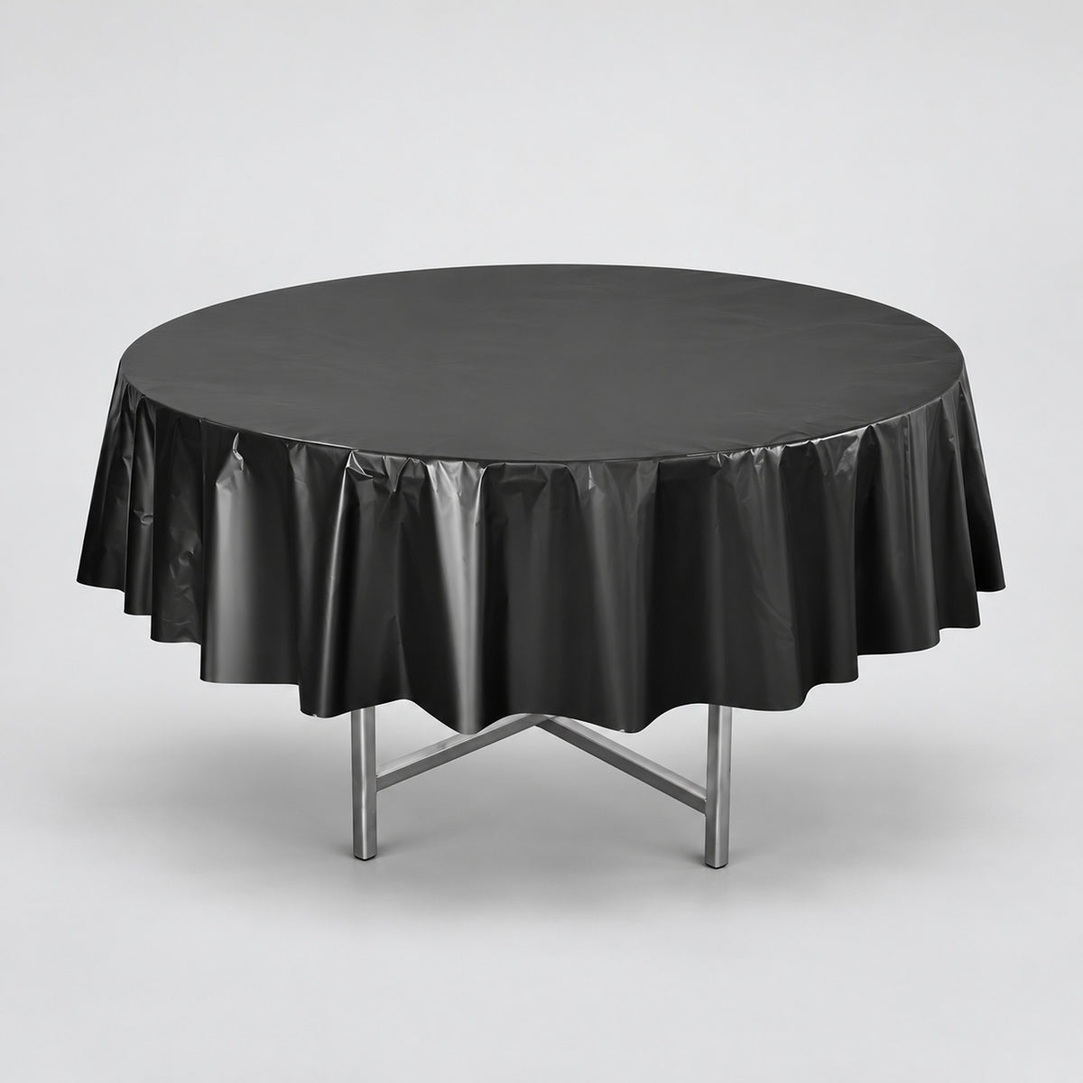 One black disposable PVC tablecloth draped over a round table.
