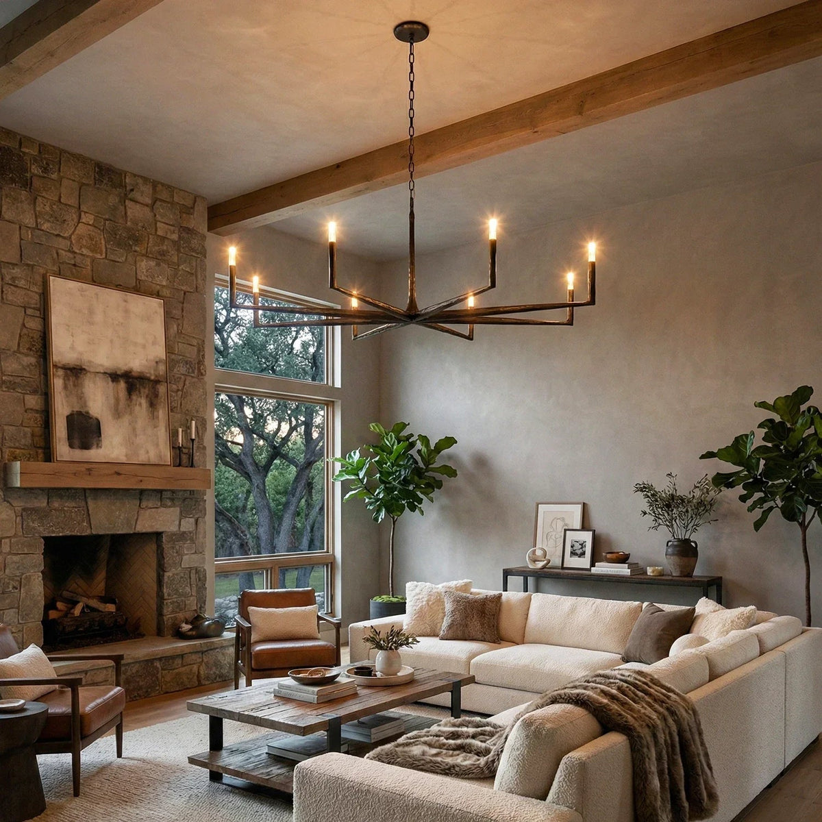 Modern living room with a stone fireplace, chandelier, and comfortable furniture.