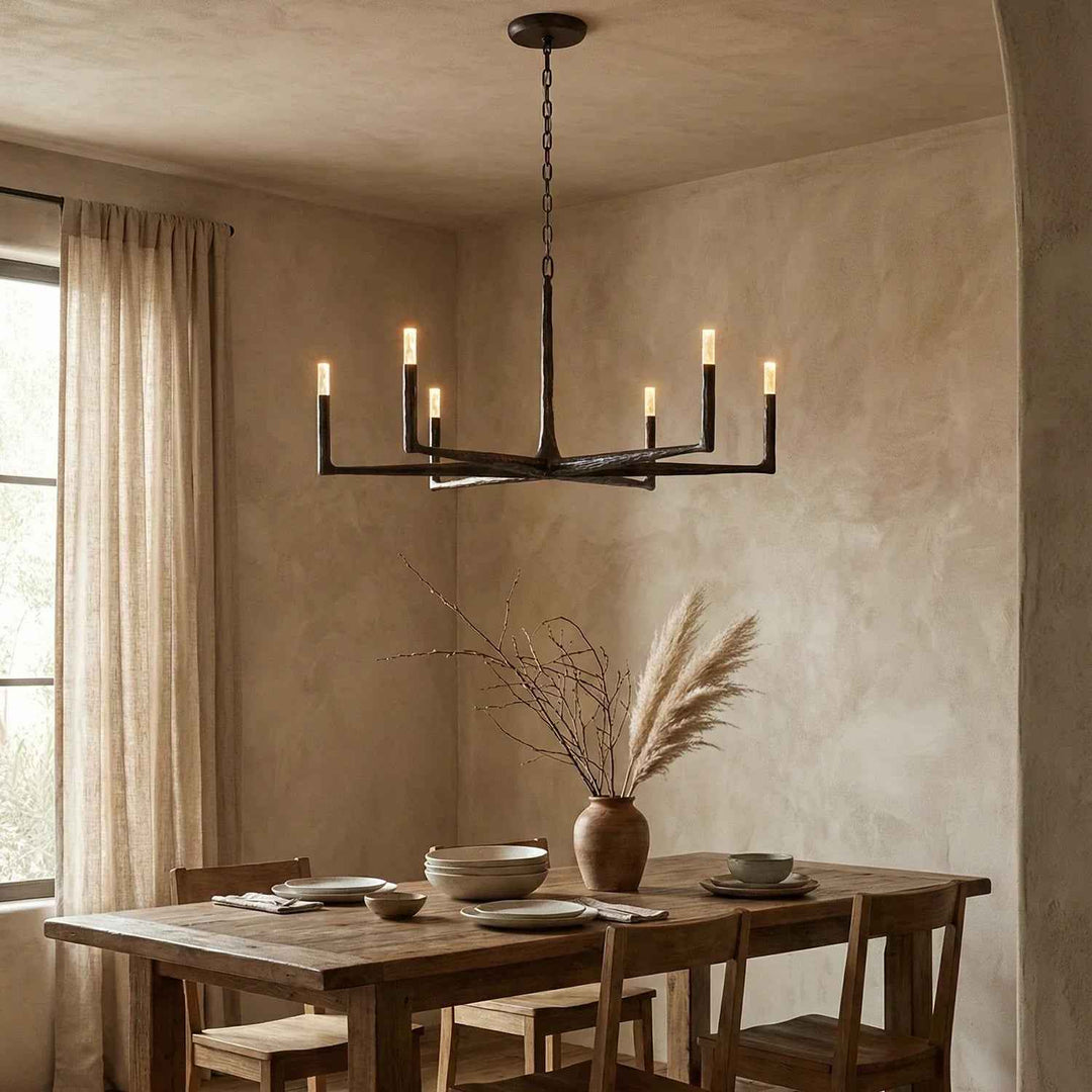 Dining room with a rustic wooden table, chairs, and a modern chandelier.
