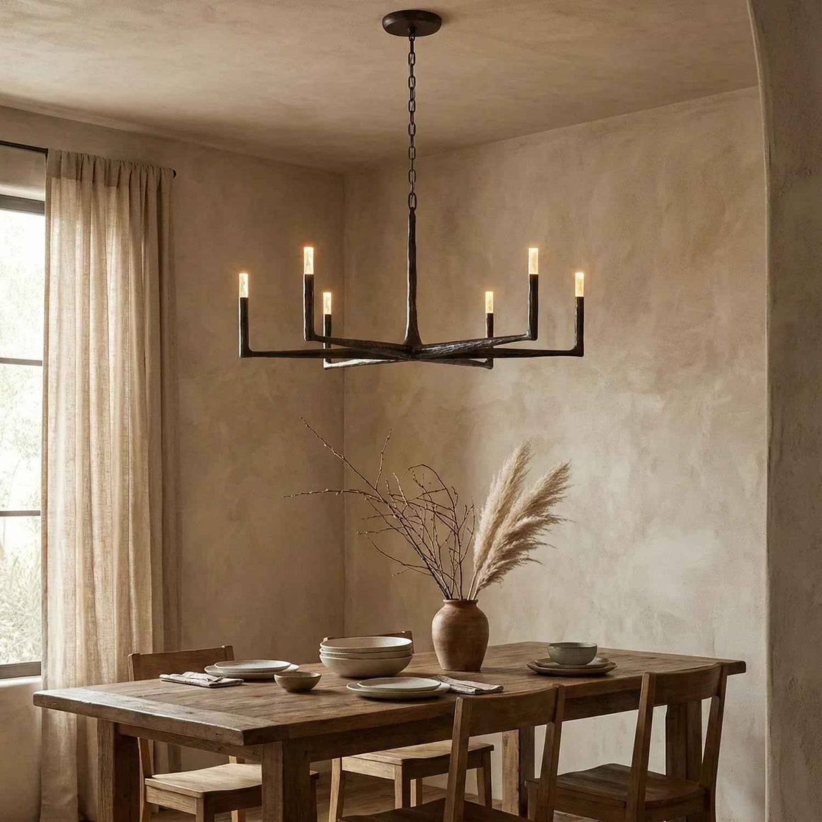 Dining room with a rustic wooden table, chairs, and a modern chandelier.