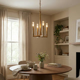 Dining room with a wooden table, chandelier, and window with curtains.