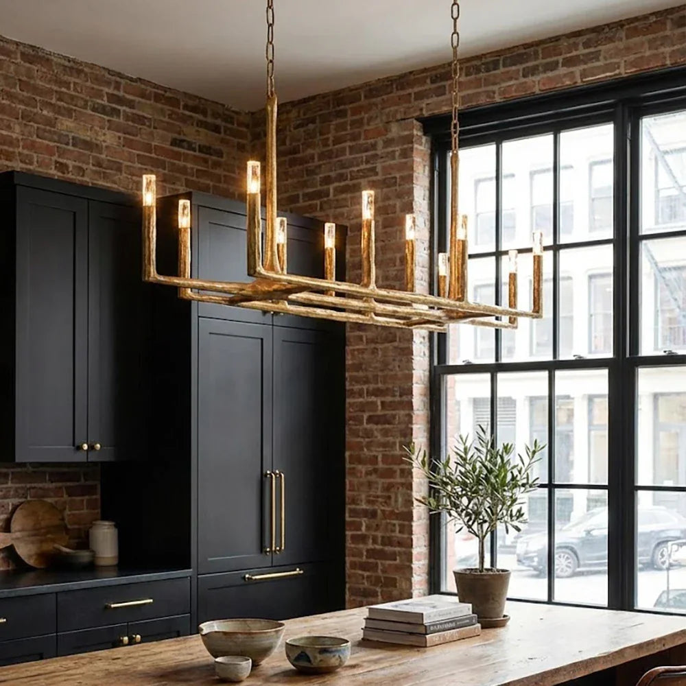Modern kitchen with a gold chandelier, dark cabinets, and a large window.