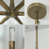 Close-ups show the brass chandelier’s hammered arms, round ceiling canopy, suspension chain, and clear faceted crystal shade.