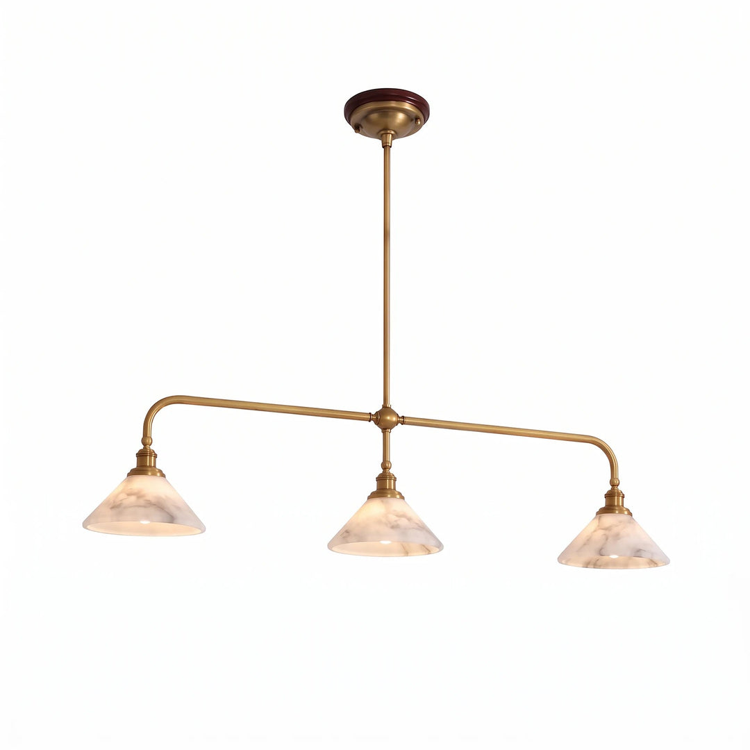 A brass pendant light with three illuminated, veined alabaster shades hangs against a white studio background.