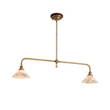 Two-light linear pendant light with a brass frame and illuminated veined alabaster shades against a white background.