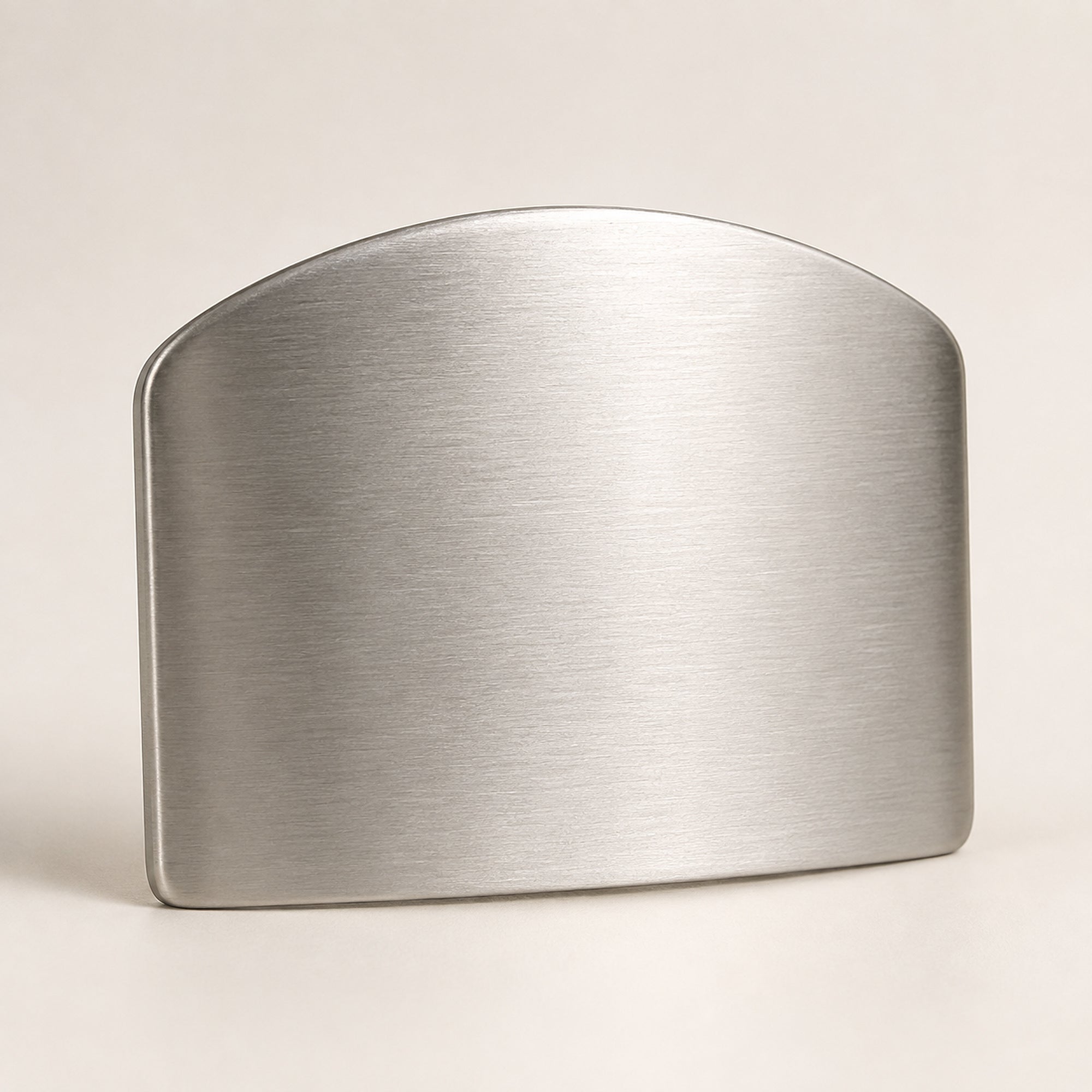 Front view of the stainless steel finger guard showing the smooth outer face the knife slides against