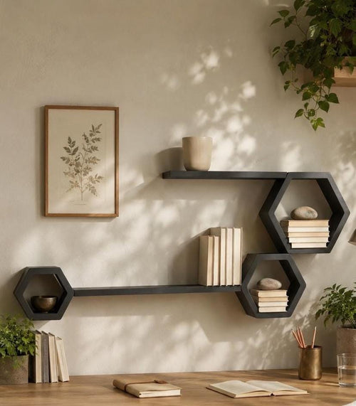 Five-piece matte black pine shelf set with books and ceramics on a cream wall