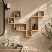 Modular pine box shelves on a bathroom wall with towels and a candle