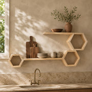 Pine ledge and hexagon shelves above a kitchen sink with boards, bowls and a vase