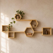 Pine hexagon and box shelves with a trailing plant on a warm cream wall