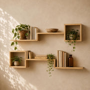 Six-piece pine cube and ledge shelf set with plants and books on a warm wall
