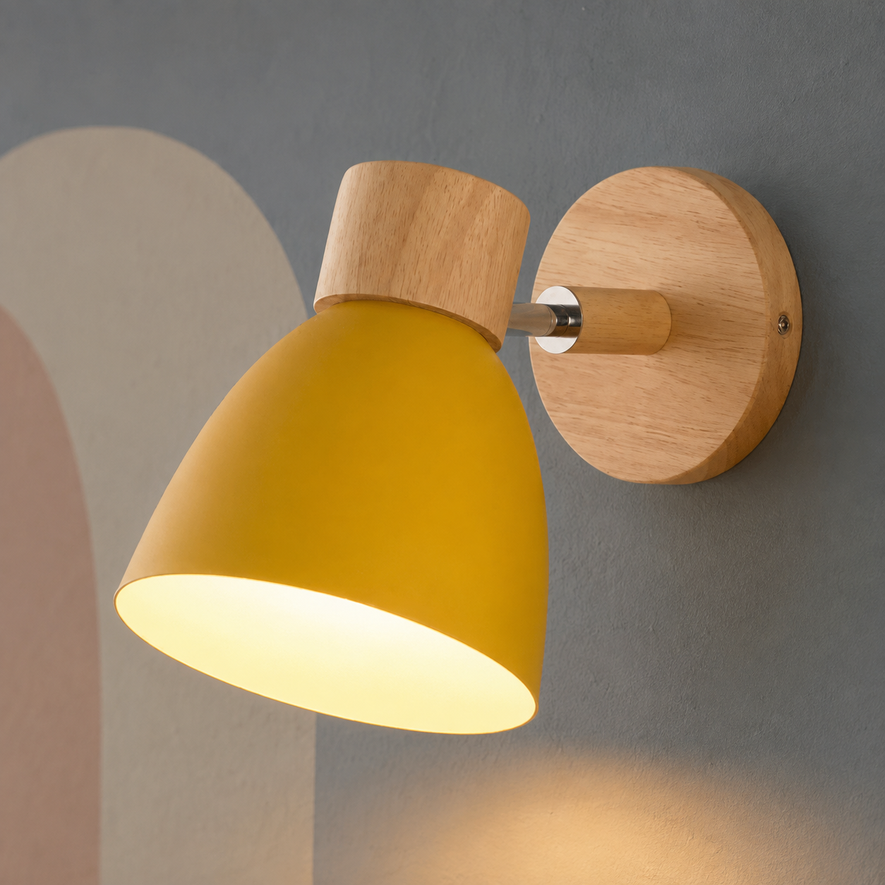 Yellow bell wall lamp with wood cap lit warm on a slate wall with pastel arch