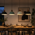 Black green and white metal pendant lights over an evening dining table