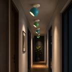 Blue and green adjustable ball ceiling lights glowing in a hallway