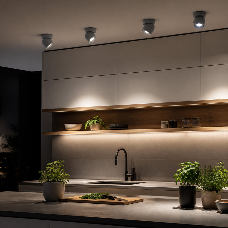 White and gray adjustable ceiling spotlights lighting a kitchen task counter