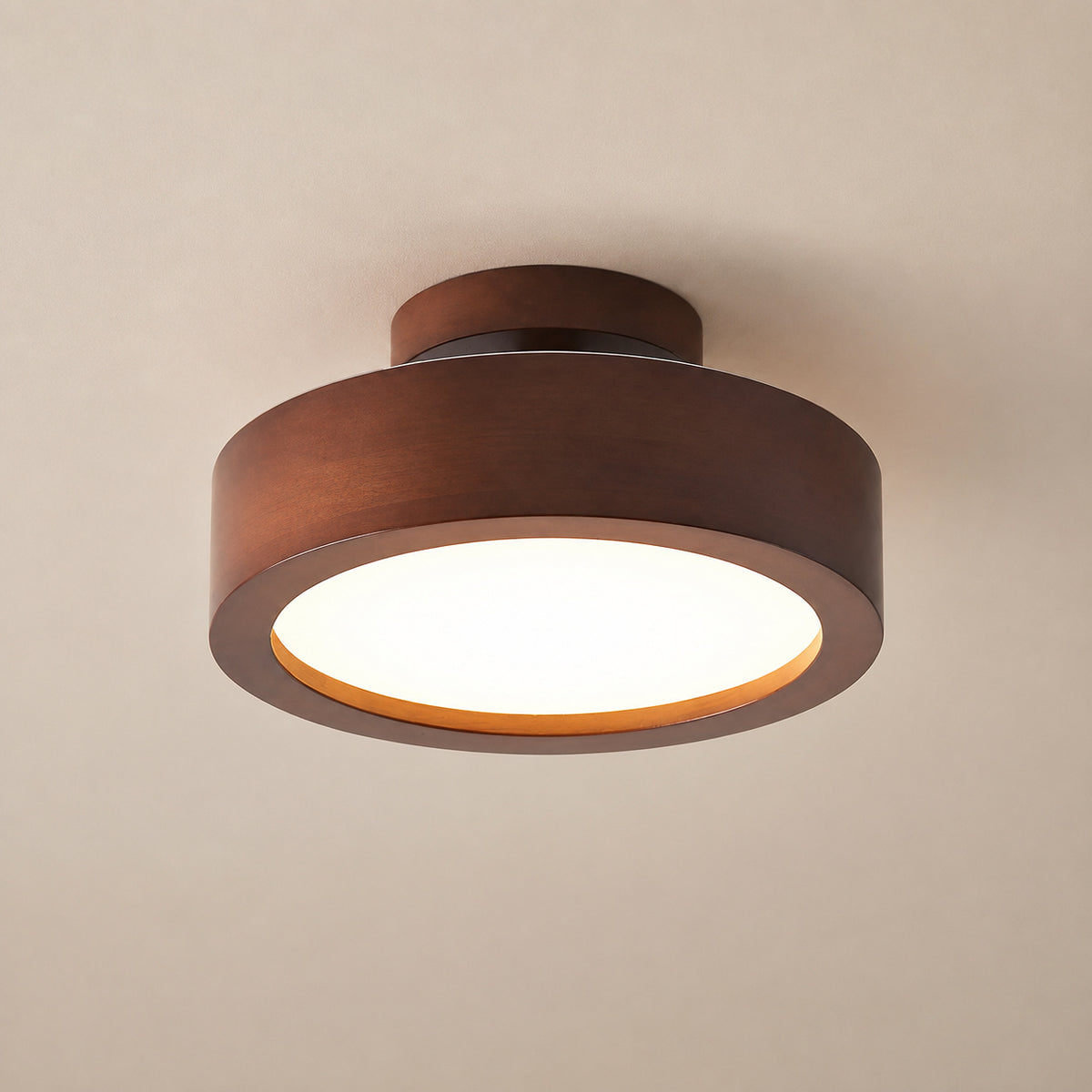 A modern semi-flush mount ceiling light fixture with a circular dark brown wood-look outer ring and a glowing white frosted glass diffuser, shown against a plain beige ceiling.