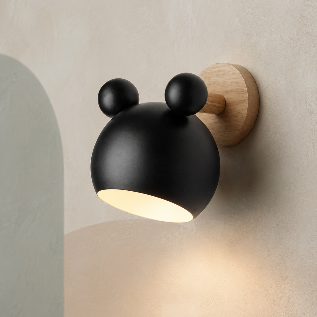 Black bear wall lamp lit warm on a greige wall with soft sage arch