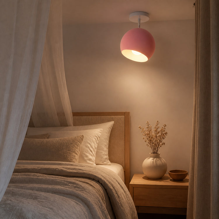 Pink modern ball ceiling light glowing in a bedroom at night