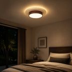 Walnut travertine flush mount ceiling light glowing in a bedroom at night