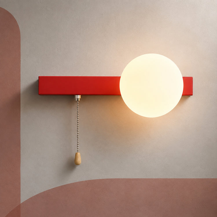 Coral red bar globe wall sconce lit warm with pull chain switch