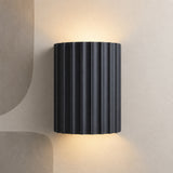 Dark charcoal fluted up down wall light on a stone wall