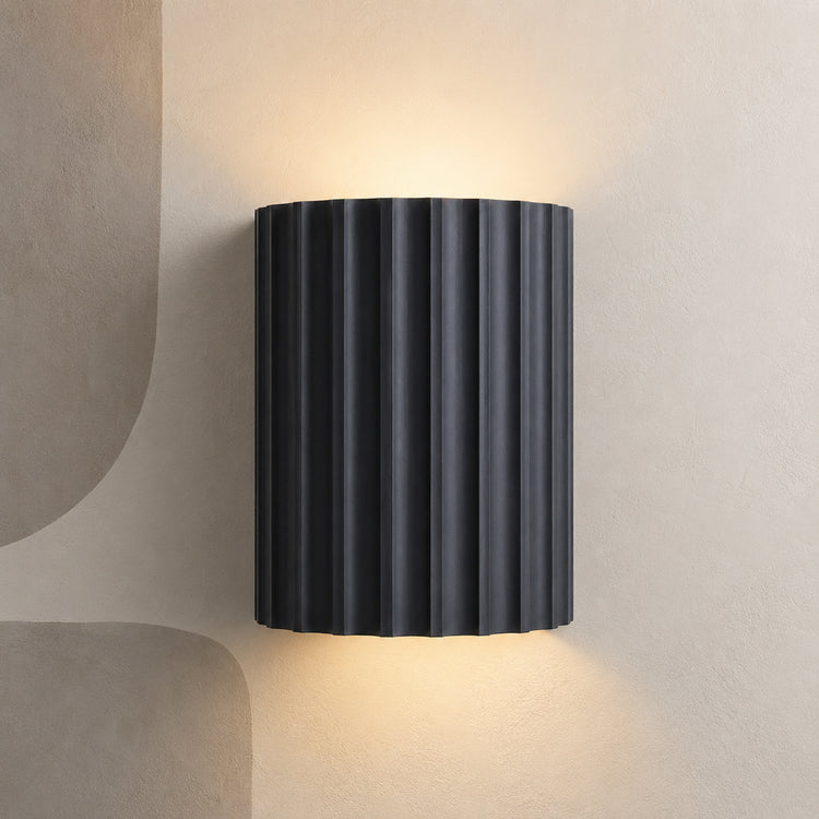 Dark charcoal fluted up down wall light on a stone wall