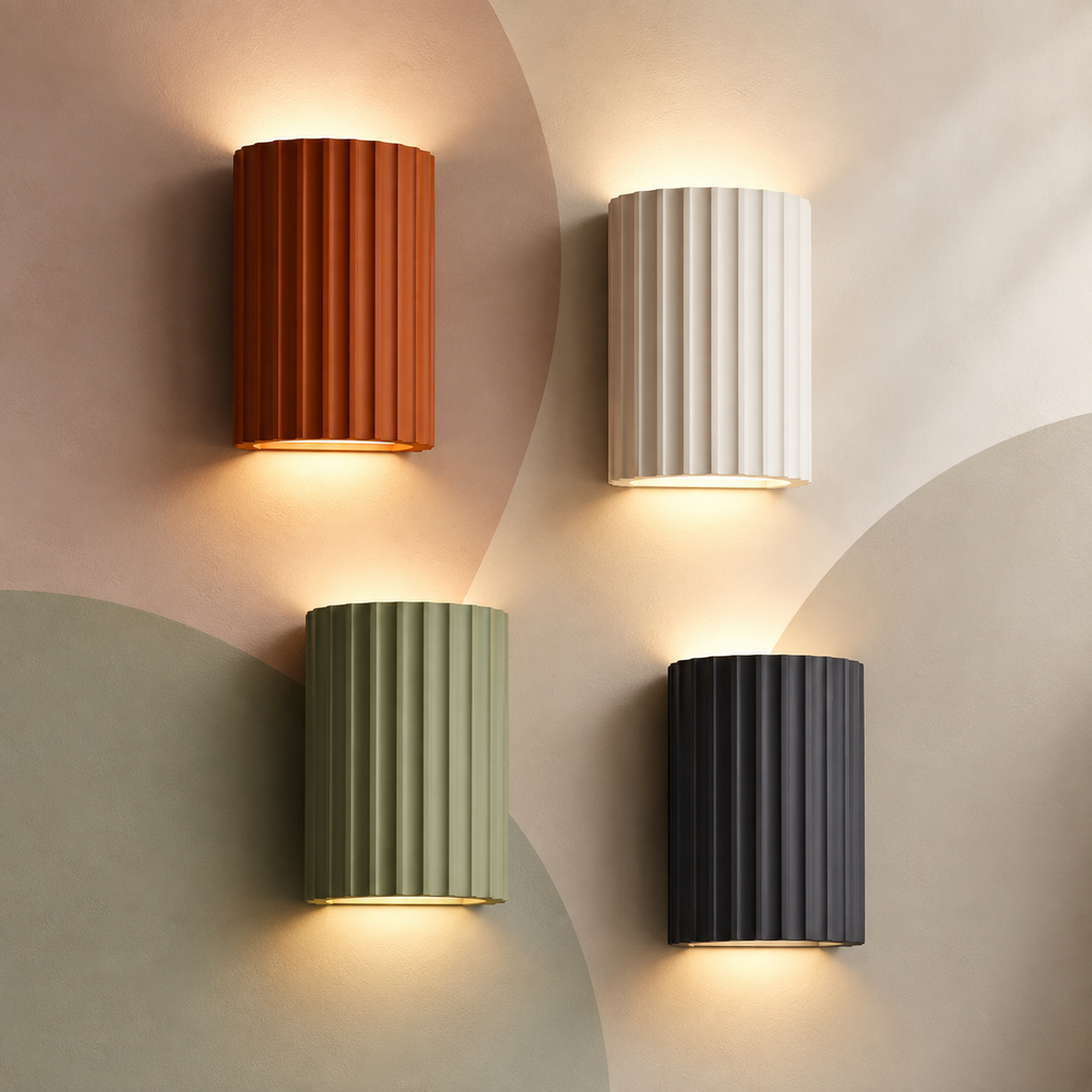 All four fluted resin up down wall sconces lit on a pastel color-block wall