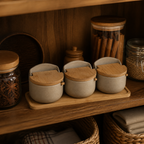 Three ceramic spice jars organized on a warm pantry shelf