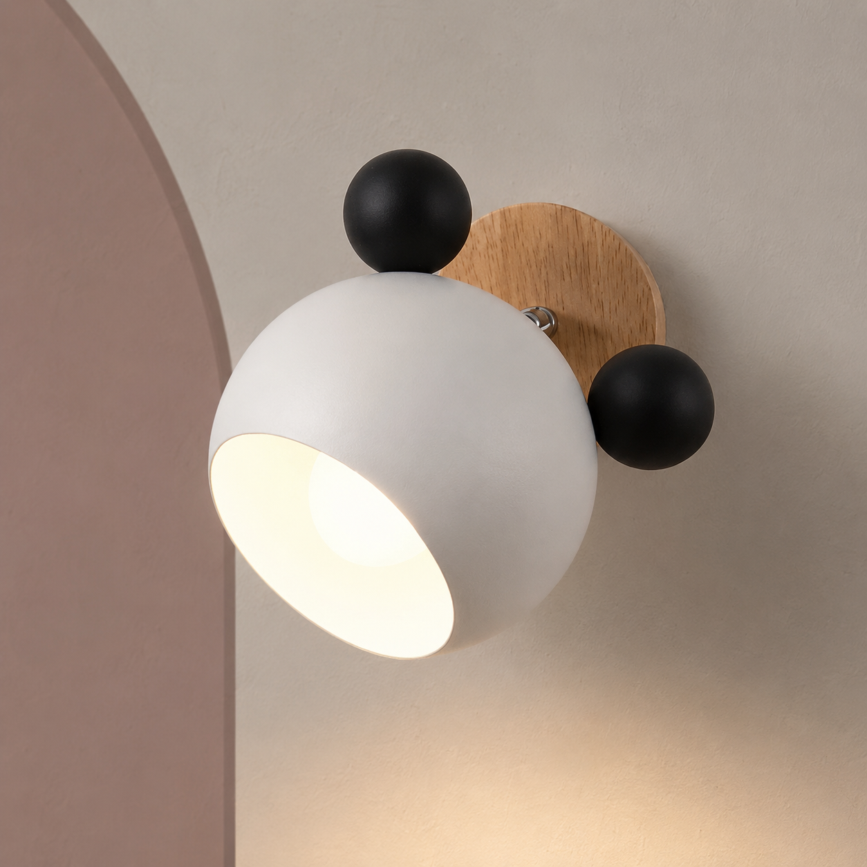 White and black bear wall sconce lit on a warm wall with dusty rose arch