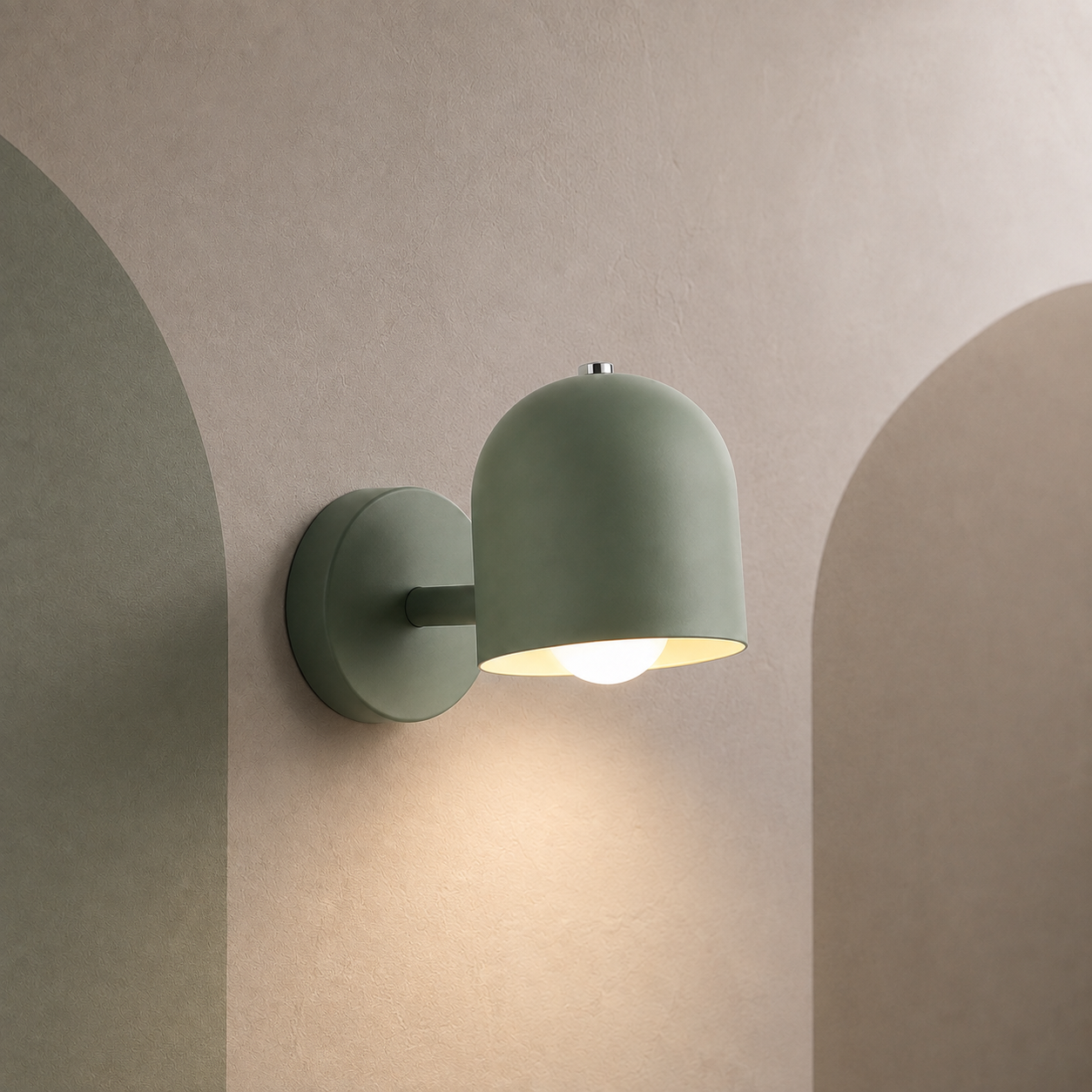Green dome bedside wall sconce lit on a warm greige wall