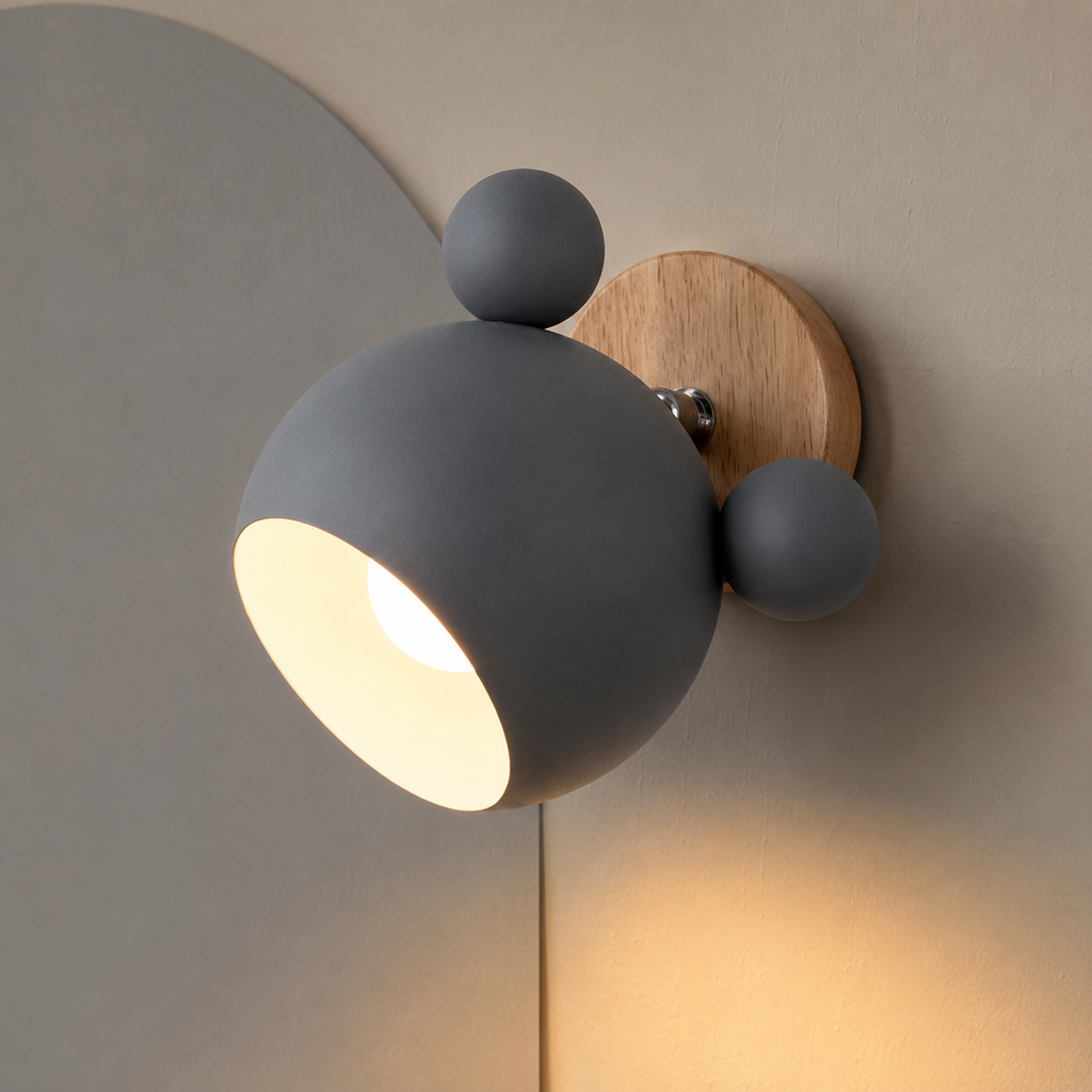 Gray adjustable wall lamp glowing warm on a mushroom wall with soft gray arch