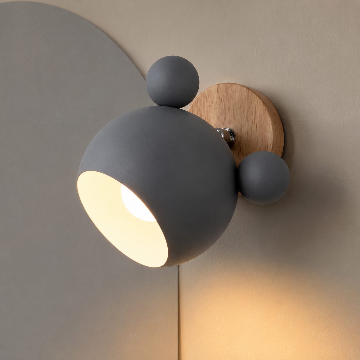 Gray adjustable wall lamp glowing warm on a mushroom wall with soft gray arch