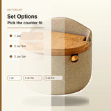 A beige speckled ceramic salt cellar container with a wooden lid and small brass knob, shown on a light cream background with overlaid text reading 'Set Options' and options for 1 Jar, 2 Jar Set, and 3 Jar Set.
