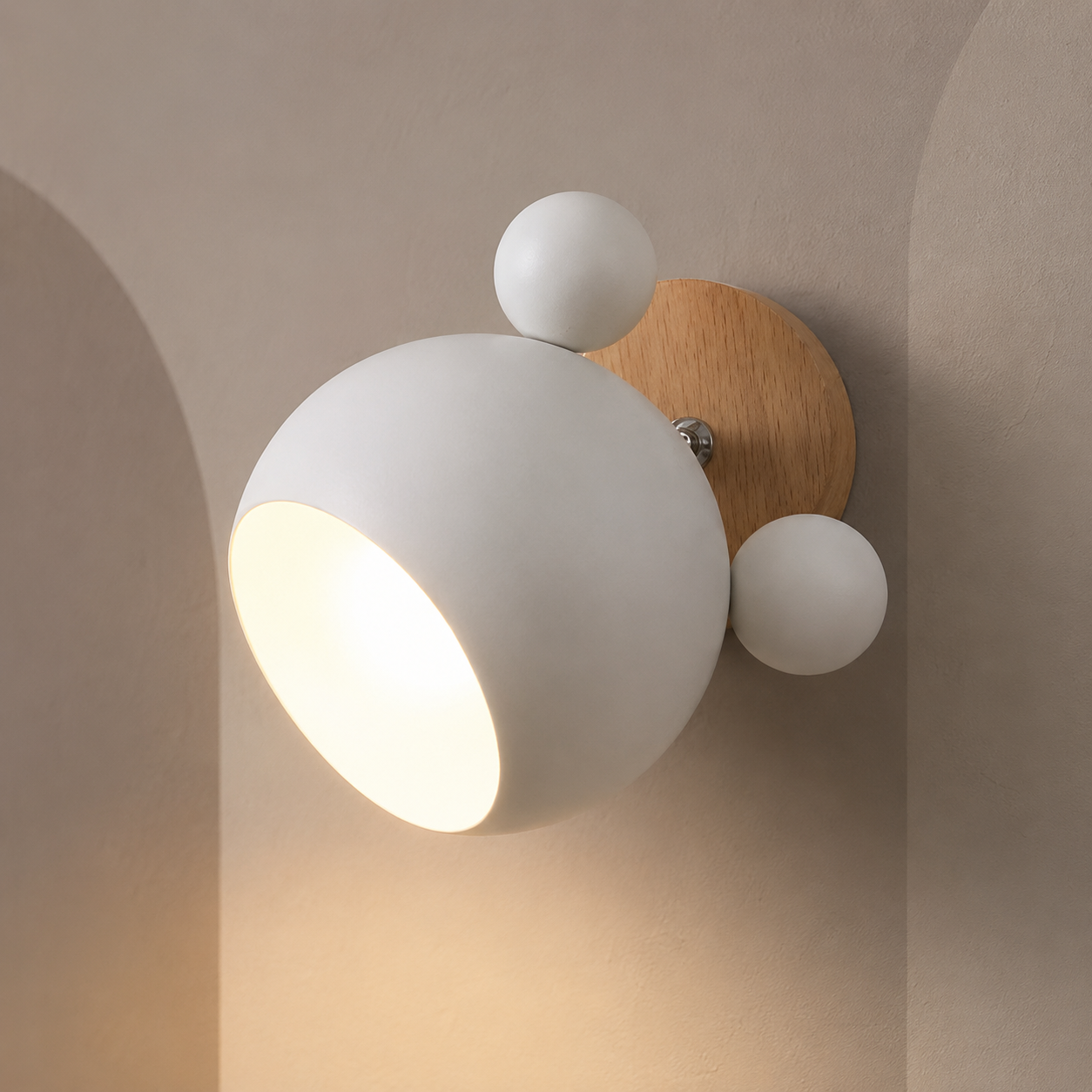 White wall lamp with wood mount lit warm on a greige wall with pale arches