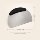 A stainless steel pastry scraper with a black silicone wrist rest, shown with dimension lines and text indicating its size as 6.3 in (16 cm) by 4.