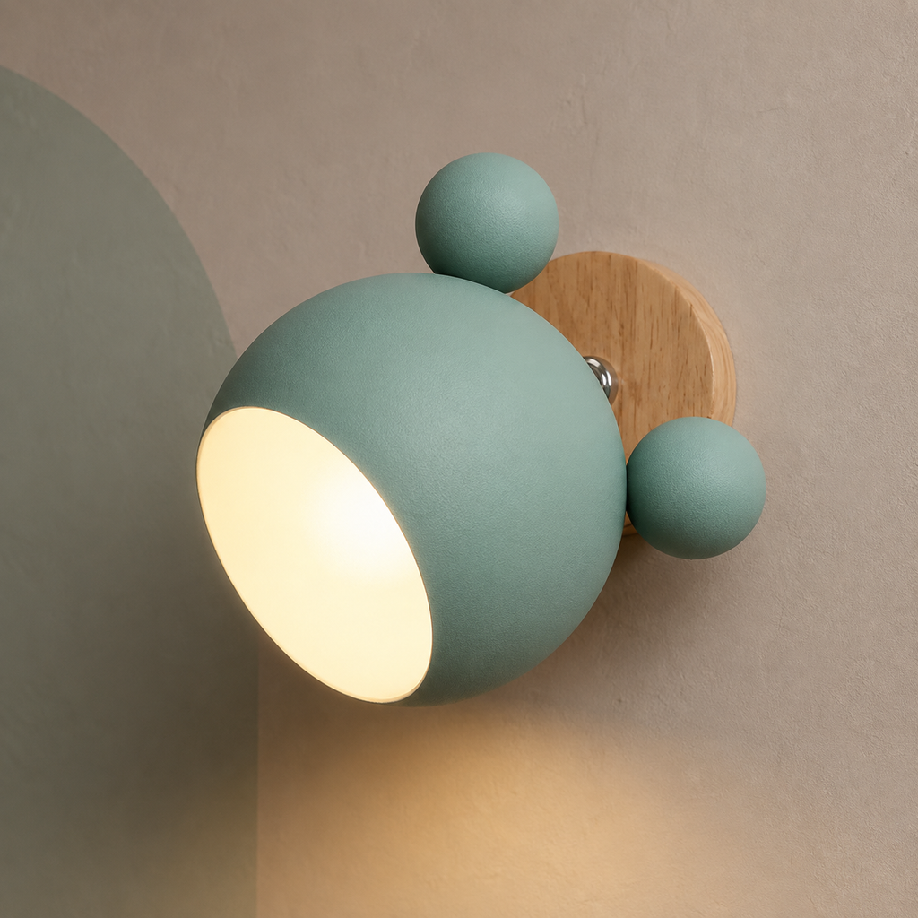 Green bear ear wall light glowing warm on a clay-gray wall with sage arch