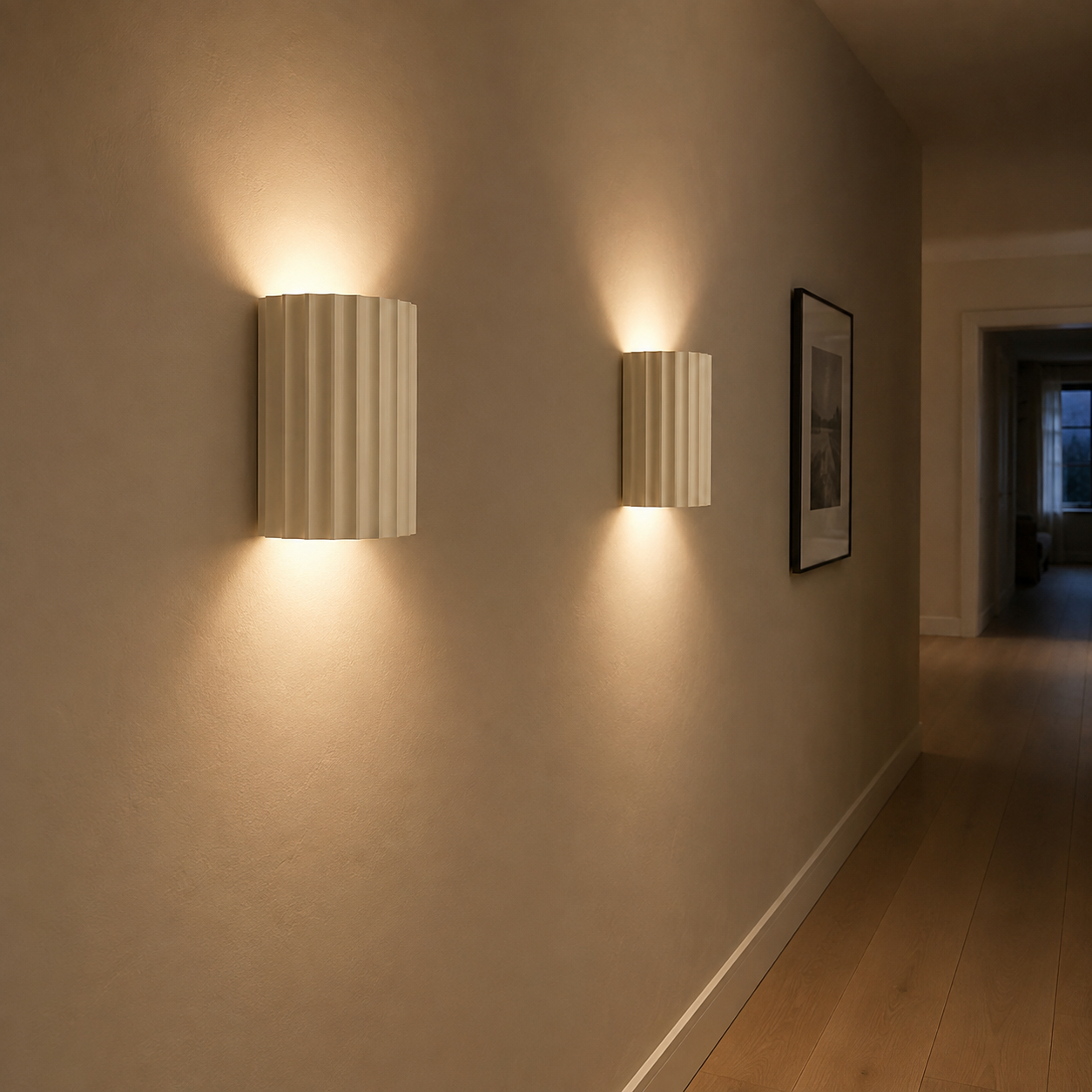 Two ivory fluted up down wall sconces lighting a narrow hallway with oak flooring