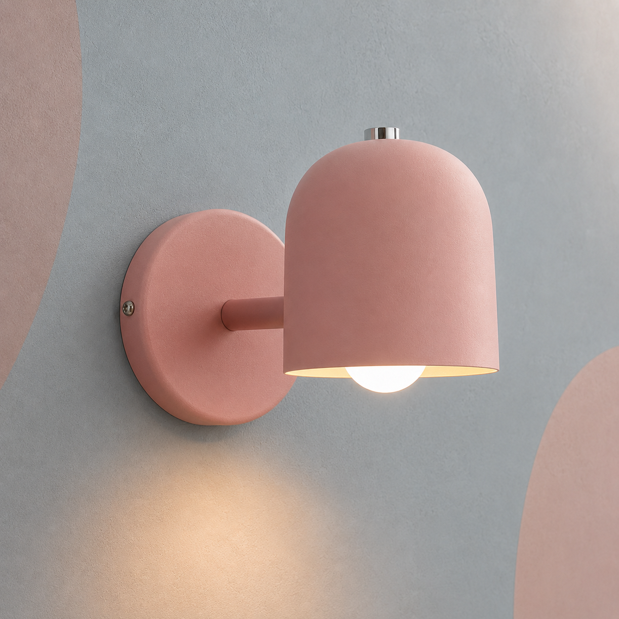 Pink dome bedside wall lamp lit warm on a blue-gray wall