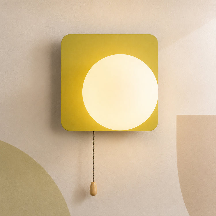 Chartreuse green square globe wall sconce lit warm with pull chain switch