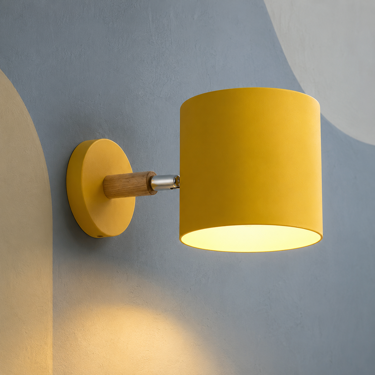 Yellow cylinder wall sconce on wood arm lit on a slate wall