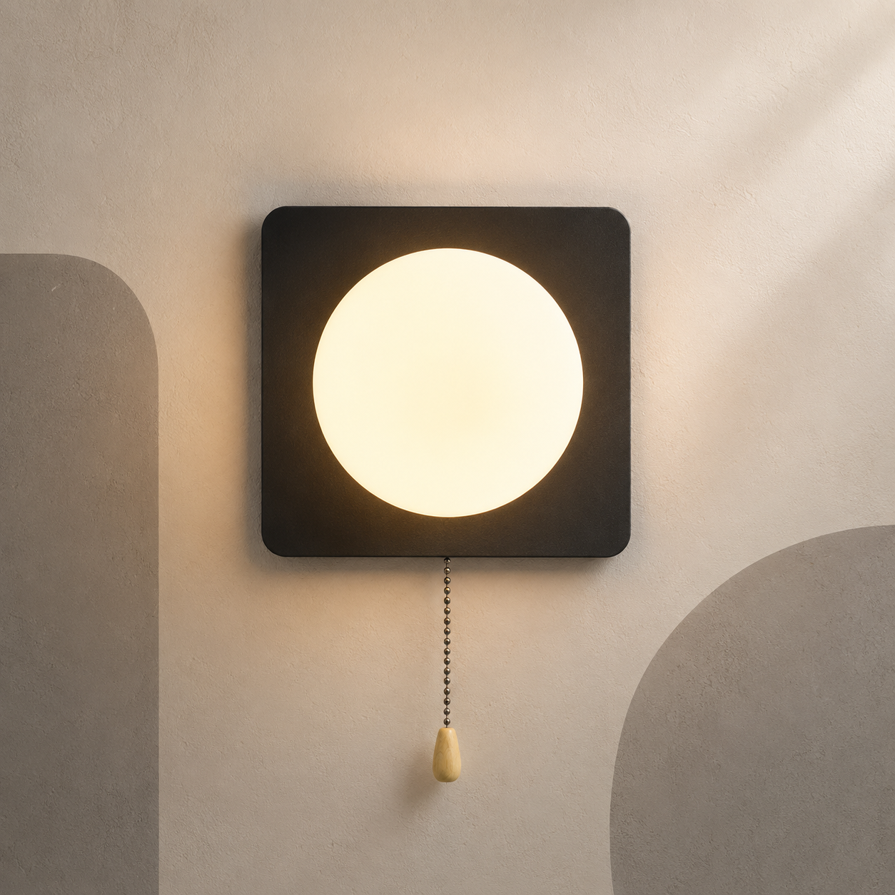 Matte black square globe wall sconce lit warm with pull chain switch