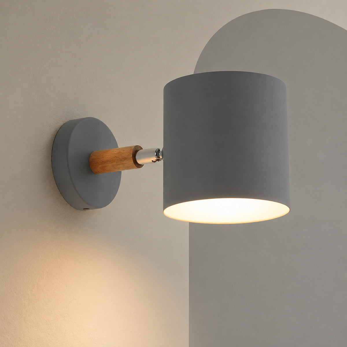 Gray cylinder wall lamp on wood arm lit on a mushroom wall